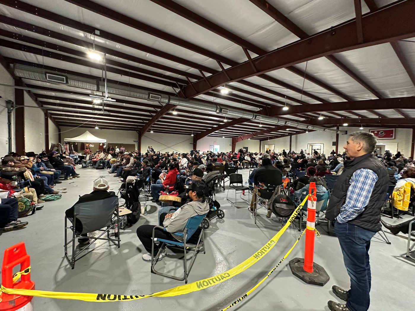 Attendees gathered indoors at the Piikani Hand Games.